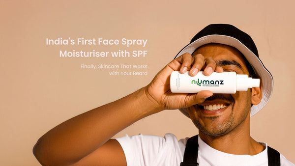 Indian man smiling while holding Numanz face spray moisturiser with SPF for men across his face. Banner text reads ‘India’s First Face Spray Moisturiser with SPF – Finally, Skincare That Works with Your Beard.’ Premium men’s skincare product image.