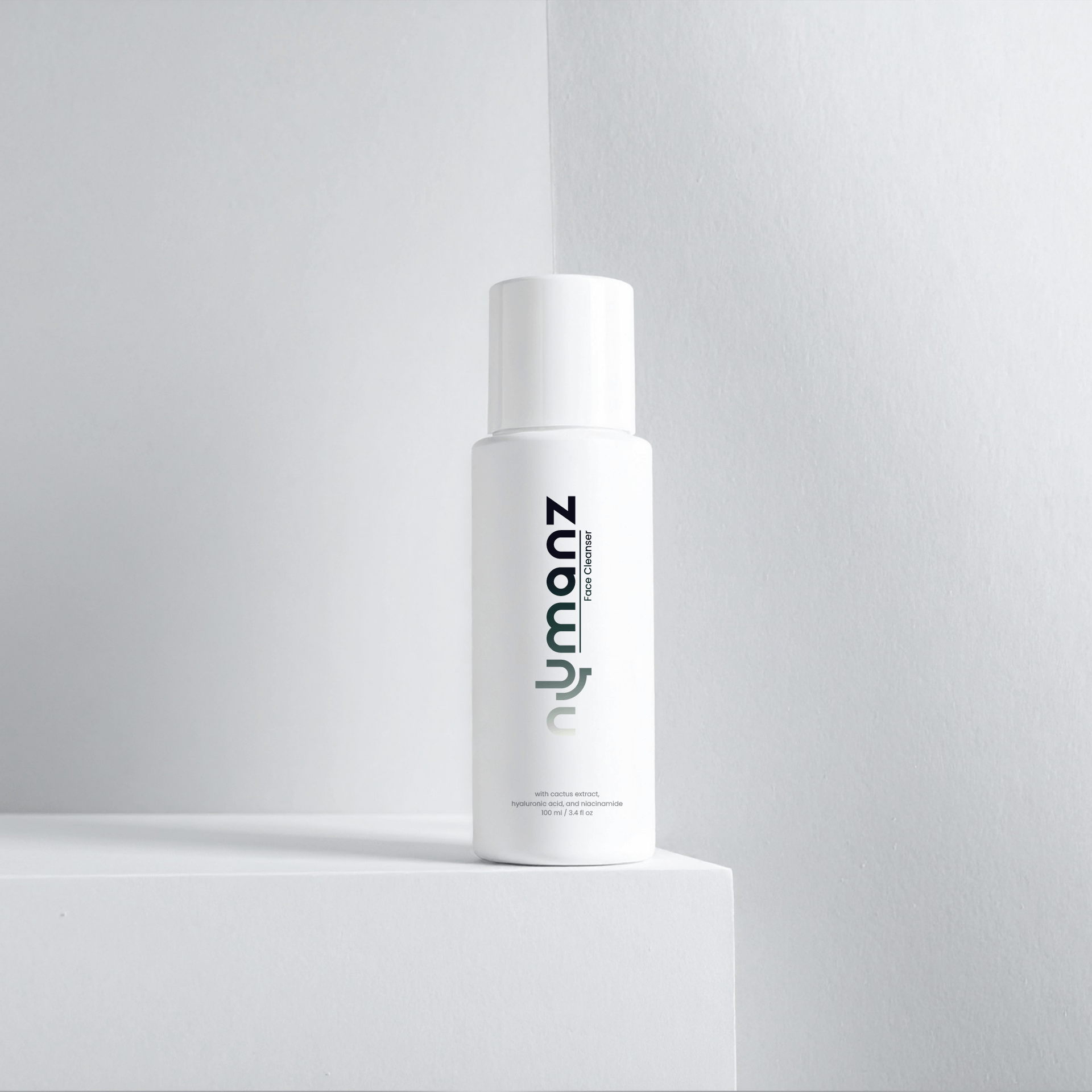 Numanz Face Cleanser Sample bottle on minimalist grey background, premium men’s skincare