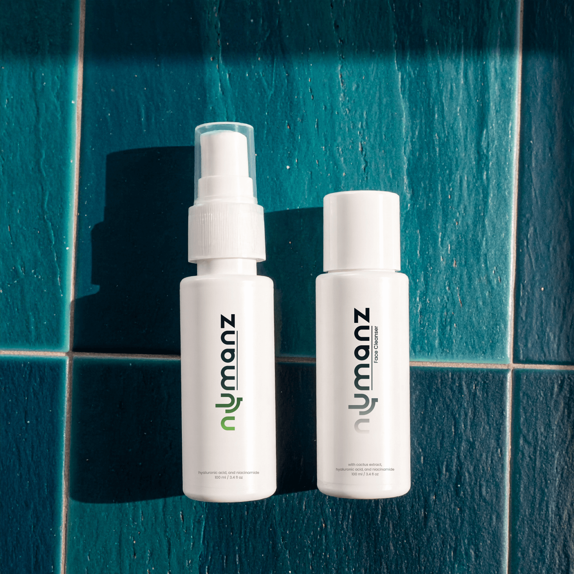 Numanz Face Cleanser and SPF 50 Moisturiser Samples on aqua blue tiles