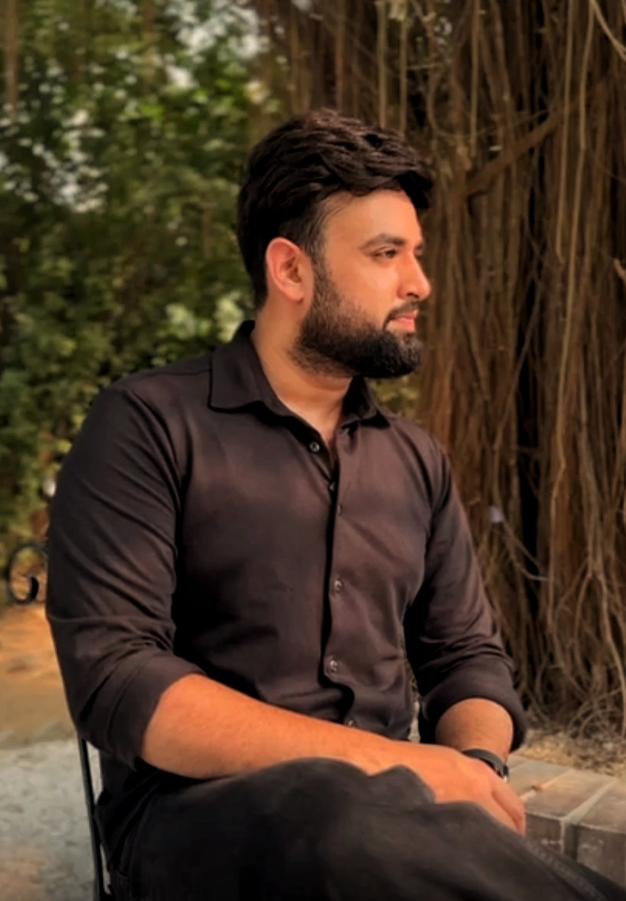Ravi Jangra, founder of Numanz men’s skincare, sitting outdoors thoughtfully, embodying leadership behind the premium cactus-powered skincare line.